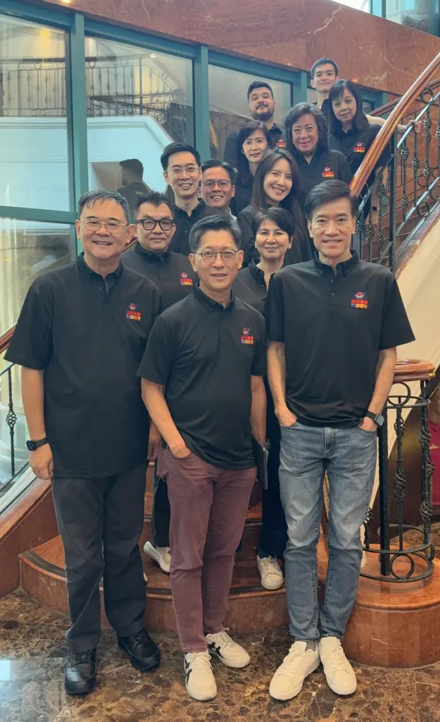 ShopNJoy team members standing together on a staircase
